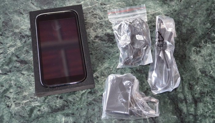 Box contents include a charger, microUSB cable and a standard pair of headphones.