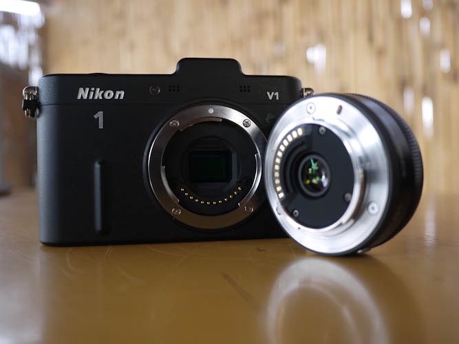 Nikon V1 houses similar CX format 10 megapixel sensor as the Nikon J1 and comes with a 10mm / f 2.8 block lens.