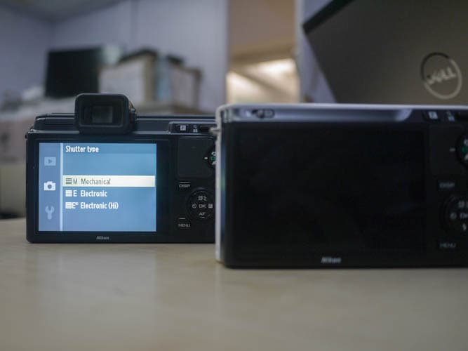 The Nikon V1 gives you an option to choose between mechanical and electronic shutter, which is not there in the Nikon J1.