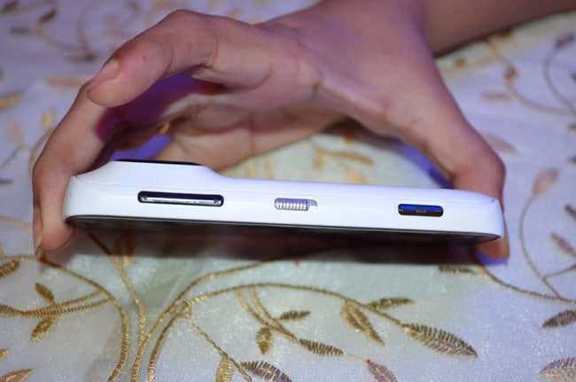 The Symbian Belle handset features the volume rocker, a dedicated camera button and a screen lock button on the right.