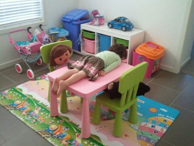 This 3 year old starts young, planking on her play table