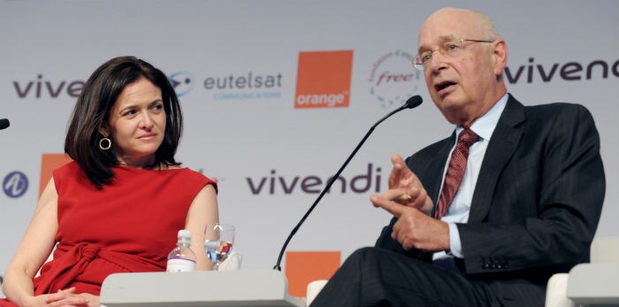Facebook's Chief Operating Officer, Sheryl Sandberg (L), listens to World Economic Forum founder and CEO Klaus Schwab during a session. (Photo: AFP)