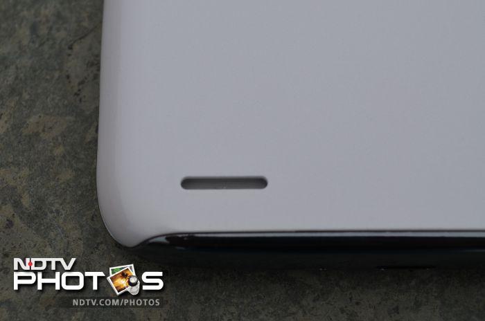 A speaker outlet is located towards the lower part of the phone's back.