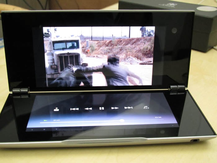 For movie viewing, the top screen serves as the primary display while the lower screen hosts the playback controls.