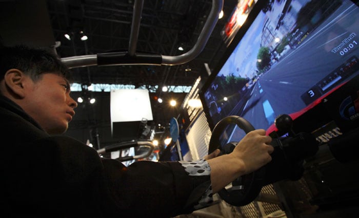 A visitor tries out  "Gran Tourismo 5," Sony's new racing simulator game for its PlayStation 3 at the Tokyo Game Show in  Makuhari, near Tokyo, Thursday, Sept. 16, 2010. Sony's PlayStation 3 game console will work as a Blu-ray disc player for 3-D movies and music videos, not just 3-D games, with a software update download starting Sept. 21. (Photo: AP)