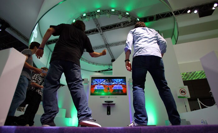 Visitors try out virtual controller-free table tennis at Microsoft's booth during the Tokyo Game Show in  Makuhari,  near Tokyo, Thursday, Sept. 16, 2010. Microsoft Corp. kicked off the Tokyo Game Show Thursday by unveiling plans to help Japanese game makers, recently seen as insular and lagging overseas competitors, to aggressively pursue a bigger share of the global market. (Photo: AP)