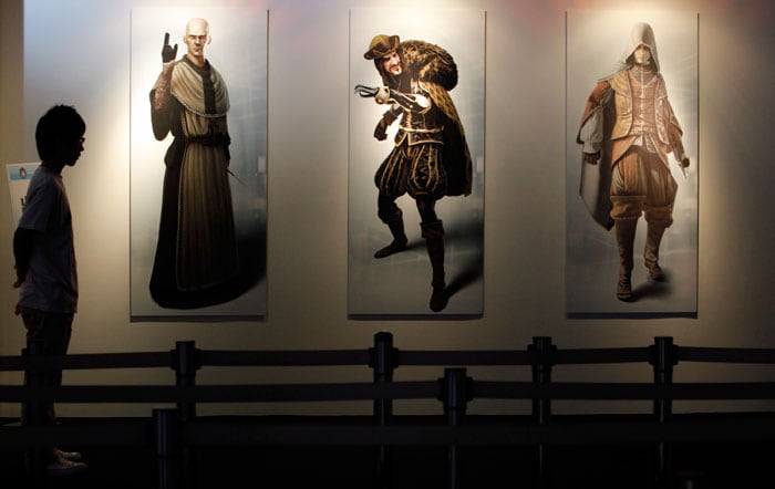 A staff member stands at the exit of a booth displaying characters from a game at the Tokyo Game Show, in Makuhari, Japan, Thursday, Sept. 16, 2010. (Photo: AP)