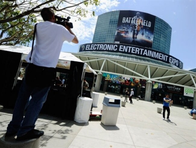 A member of the media using a video camera records the front entrance of the Los Angeles Convention Center in preparation for the E3 Expo. (Photo: AFP)