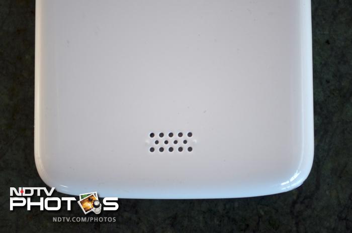 The speaker outlet is located towards the lower part of the phone's back.