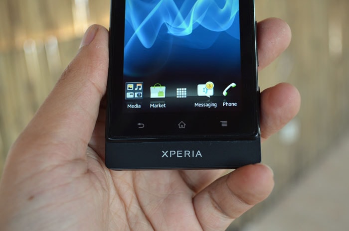 Below the screen there are three capacitive touch buttons.