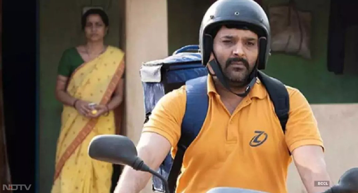 अपनी कॉमिडी से लोगों को लोटपोट करने वाले कपिल शर्मा ने इस दफा एक गंभीर किरदार में खुद को ढाला है। फ‍िल्‍म ‘ज्विगाटो' में वह एक डिलीवरी बॉय की भूमिका निभा रहे हैं। उनकी पत्‍नी का रोल निभाया है शहाना गोस्‍वामी ने, जिनसे इंडस्‍ट्री और दर्शक भली-भांति परिचित हैं। कहानी में दिखाया गया है कि मानस का किरदार निभा रहे कपिल शर्मा की कोरोना काल में जॉब चली जाती है। परिवार की जिम्‍मेदार उठाने के लिए वह बनते हैं डिलिवरी बॉय। जैसाकि हम जानते हैं चाहे डिलिवरी बॉय हो या कैब ड्राइवर, हर कोई कस्‍टमर ने बढ़‍िया रेटिंग की उम्‍मीद करता है। फ‍िल्‍म में दिखाया गया है कि 5 स्‍टार रेटिंग के लिए कपिल कितनी जद्दोजहद करते हैं।