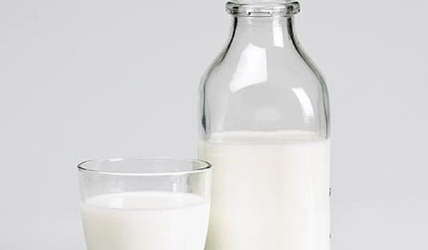 You should avoid drinking milk as it causes mucus to form and coat your throat making it very difficult for you to swallow and cough.