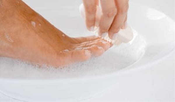 Wash your feet with an antiseptic after coming back to home if you have been out in the rains. Scrubbing them ensures that all the dirt is washed away.