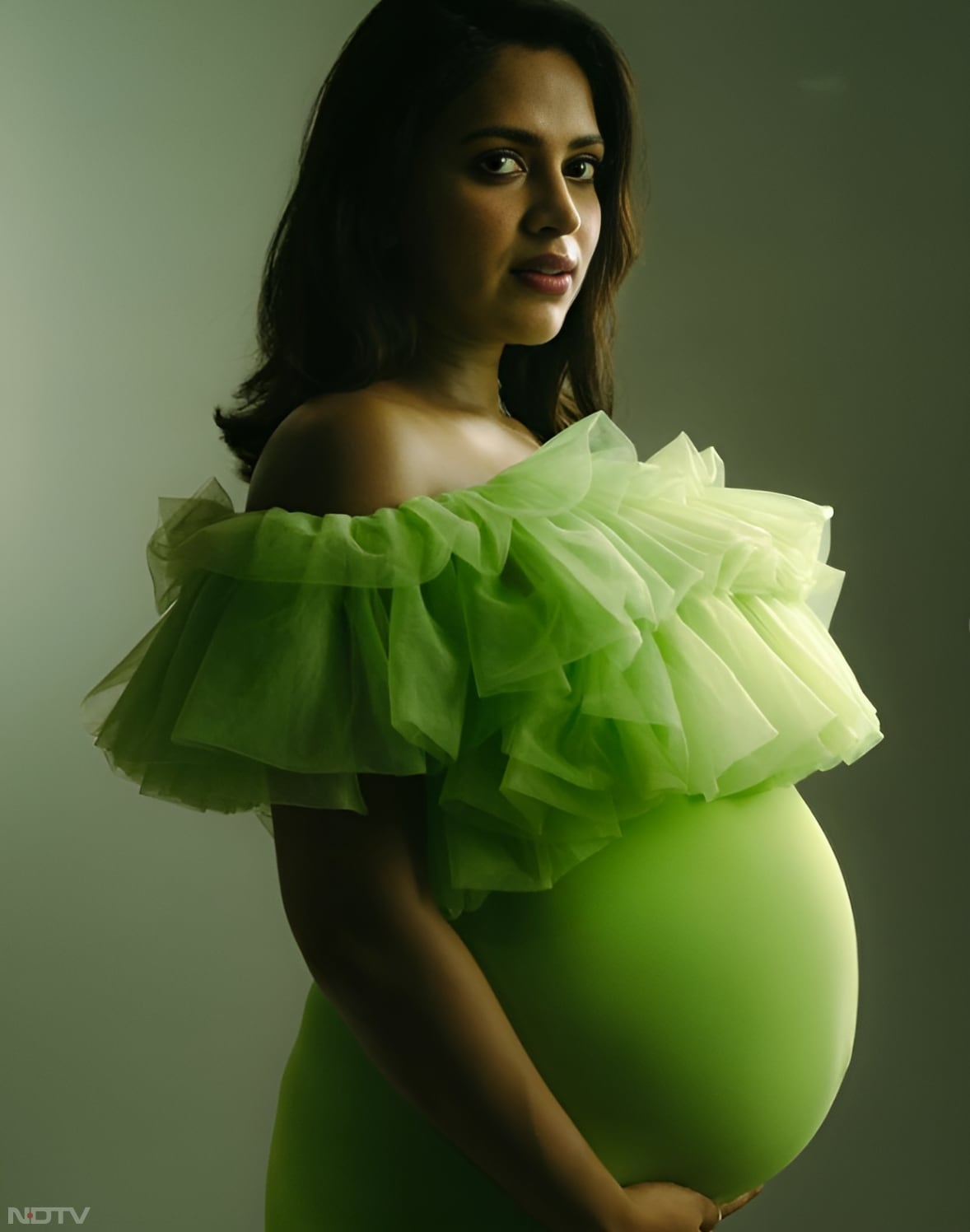 Amala Paul opted for an apple green bodycon dress with ruffled shoulders, that elegantly accentuated her baby bump. (Instagram/@amalapaul)