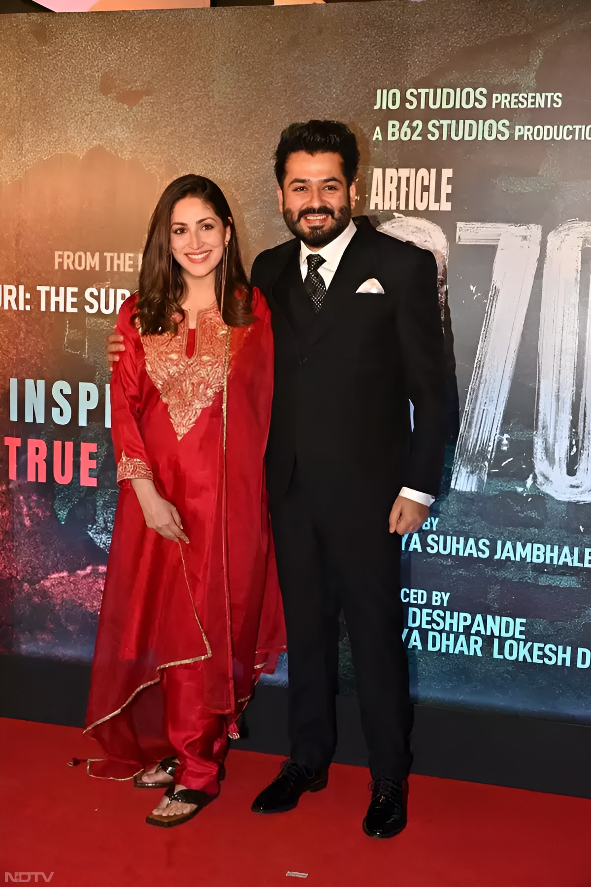 New mother Yami Gautam wore a stunning red suit embellished with intricate V-shaped golden embroidery on the front, paired with matching red straight-fit pants. (Instagram/@yamigautam)