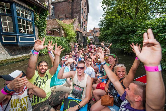 Guests of Tomorrowland festival enjoy a boat trip in Brugge. Highlights of the festival were the Cloud Rider, the highest mobile Ferris wheel in Europe, and the fact that 25 airlines were organized to bring spectators to the festival from all over the world.