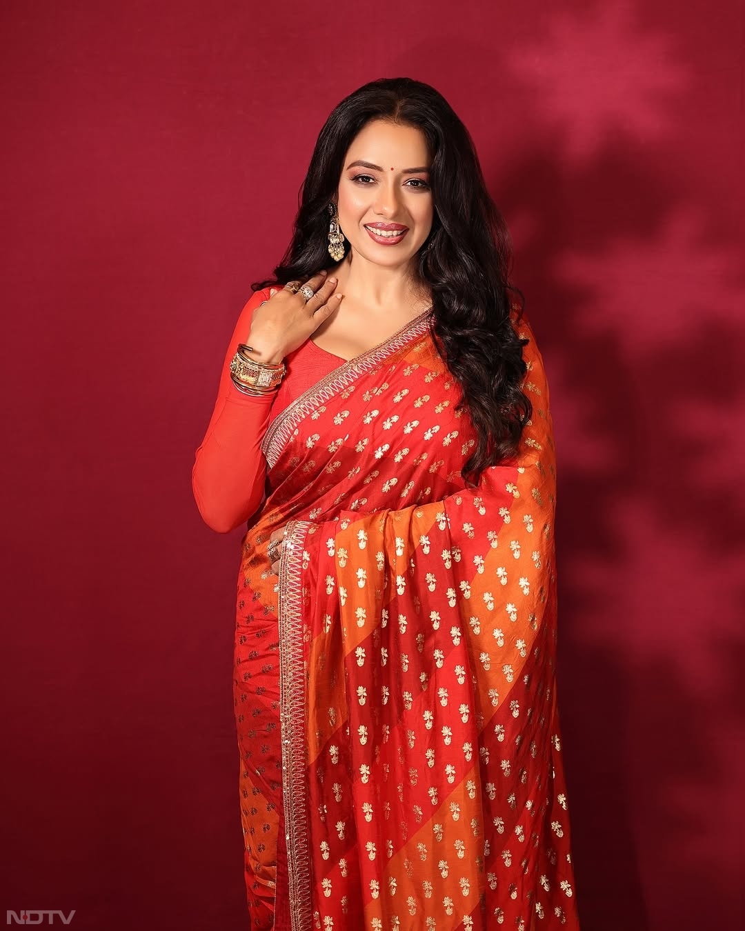 अगर आप चाहें तो रेड-ऑरेंज का ऐसा कॉम्&zwj;बो भी पहन सकती हैं या इस तरह के दूसरे मिक्&zwj;स कलर की साड़ी खरीद सकती हैं. rupaliganguly/Instagram