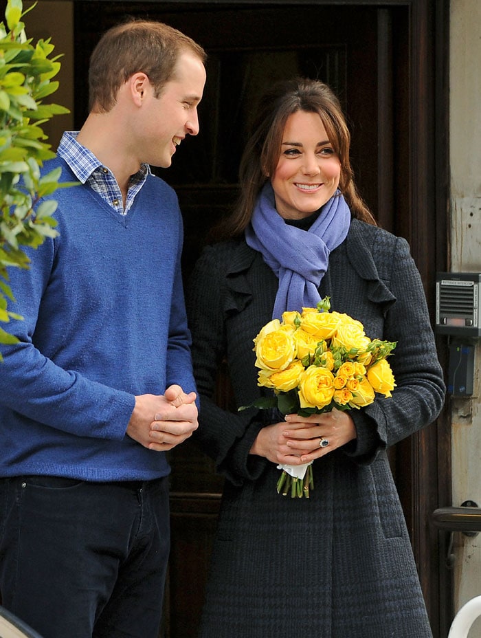 The Duchess of Cambridge, holding a bouquet of flowers, smiles and poses alongside proud husband Prince William. While Kate was in hospital, two Australian radio jockeys prank called the ward pretending to be the Queen and Prince Charles and were, astonishingly, given an account of Kate's medical condition.