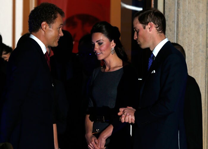 The Duchess and Duke of Cambridge speak to one of the guests at the event.