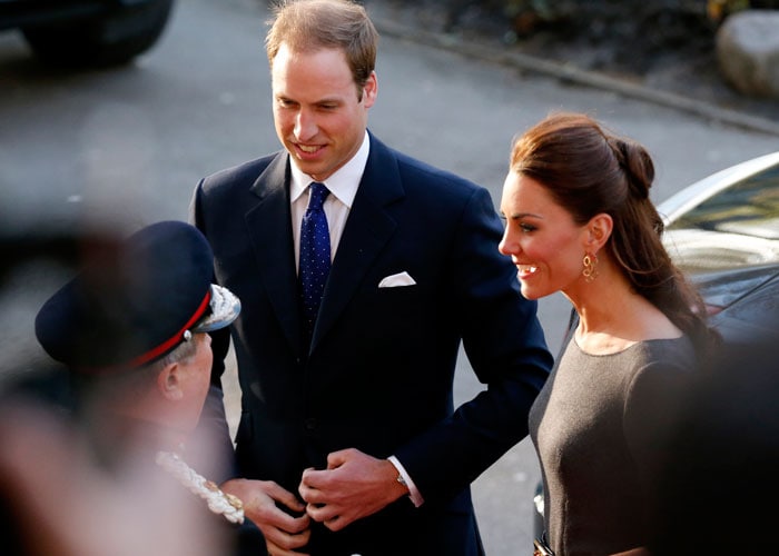 Prince William looked handsome in his dark blue suit. In this picture, the Royal couple are greeted by the officers as they arrive for the reception.