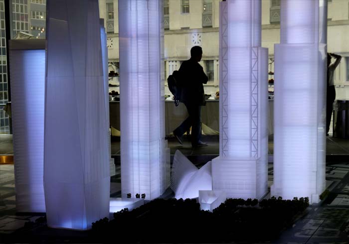 A man walks past an illuminated model of the building plan for Ground Zero at 7, World Trade Centre in New York.(AP Photo)