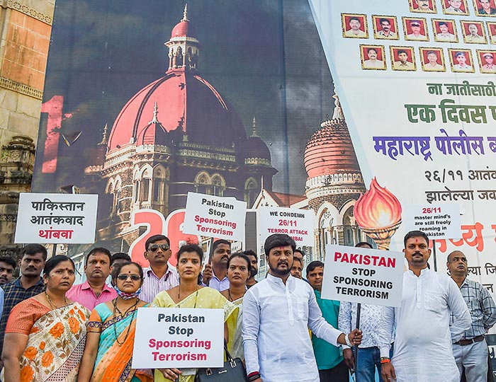 Members of Police Charitable Trust hold placards at the Gateway of India to mark the 13th anniversary of the 26/11 terror attacks.