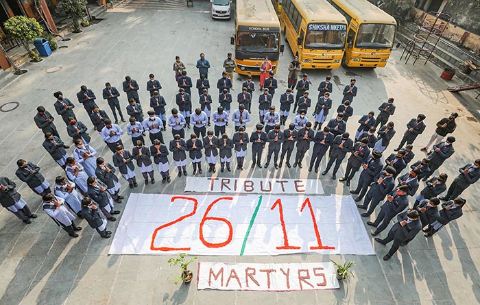 School students pay tribute to the victims of the 26/11 Mumbai terror attacks in Jammu.