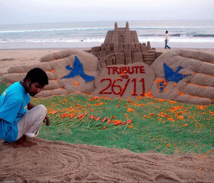 As his tribute to the victims of 26/11 Mumbai terror attacks, sand artist Sudarshan Pattnaik creates a sand sculpture at Puri beach of Orissa. (PTI Photo)