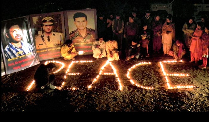 People light candles during an all-religion prayer organised to pay tribute to the martyrs of 26/11 Mumbai terror attacks on its 2nd anniversary in Jammu. (PTI Photo)