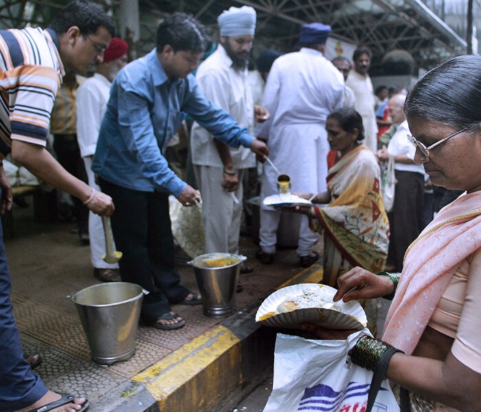 During the chaotic Mumbai terror attacks, ordinary Mumbaikars came together from all walks of life to offer help. A group of young Sikhs offered food and water to security forces battling terrorists at Oberoi and Taj hotels. The <I>chai wallahs</I> chipped in with free food and shopping malls nearby the terror sites helped the media personnel in sending their crucial database to respective sources. 
<br /> <br /> 
In extraordinary circumstances, these people rose above the stature of mere human beings while serving humanity. Indeed, they are our unsung heroes.(AFP photo)
<br><br>
<b>NDTV's tribute to Mumbai martyrs</b><br><br>

<object width="192" height="20" data="http://drop.ndtv.com/audio/player/mp3player.swf" type="application/x-shockwave-flash">

<param name="movie" value="http://drop.ndtv.com/audio/player/mp3player.swf" />

<param name="FlashVars" value="mp3=http://drop.ndtv.com/audio/news/2611_tribute/mumbai_attacks_26_11_a_tribute_to_the_martyrs_low.mp3&amp;buttoncolor=ffffff&amp;buttonovercolor=000000&amp;bgcolor1=7d7d7d&amp;bgcolor2=333333&amp;sliderovercolor=ffffff&amp;showstop=1&amp;showvolume=1&amp;autoplay=0" /></object><br /><br>

<a href="http://drop.ndtv.com/audio/news/2611_tribute/mumbai_attacks_26_11_a_tribute_to_the_martyrs_high.zip" class="fbld fn fl">Click here to download MP3</a> [1.55 MB]