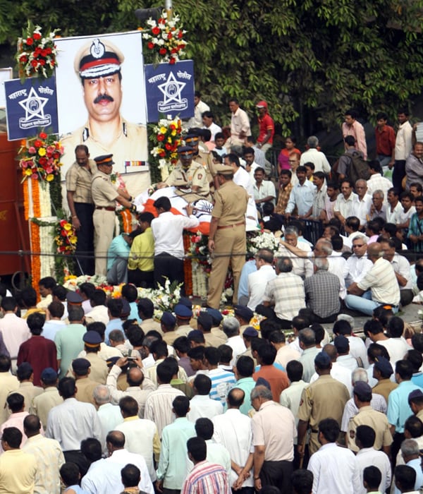 Vijay Salaskar?s funeral was also attended by family, friends and more than 10,000 other people who offered their respect to the man who gave his life to save theirs.(AFP photo)
<br><br>
<b>NDTV's tribute to Mumbai martyrs</b><br><br>

<object width="192" height="20" data="http://drop.ndtv.com/audio/player/mp3player.swf" type="application/x-shockwave-flash">

<param name="movie" value="http://drop.ndtv.com/audio/player/mp3player.swf" />

<param name="FlashVars" value="mp3=http://drop.ndtv.com/audio/news/2611_tribute/mumbai_attacks_26_11_a_tribute_to_the_martyrs_low.mp3&amp;buttoncolor=ffffff&amp;buttonovercolor=000000&amp;bgcolor1=7d7d7d&amp;bgcolor2=333333&amp;sliderovercolor=ffffff&amp;showstop=1&amp;showvolume=1&amp;autoplay=0" /></object><br /><br>

<a href="http://drop.ndtv.com/audio/news/2611_tribute/mumbai_attacks_26_11_a_tribute_to_the_martyrs_high.zip" class="fbld fn fl">Click here to download MP3</a> [1.55 MB]