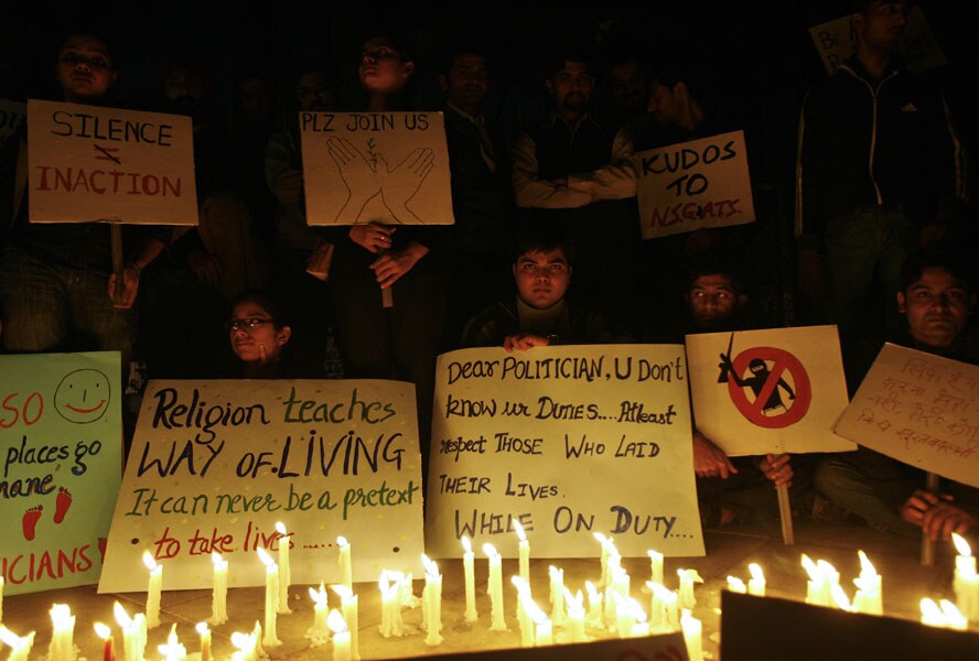 Posters and placards vividly captured the anger and concern as young and old, women and children thronged the iconic red sandstone Gateway to India opposite the Taj Mahal Hotel which along with Trident-Oberoi Hotel, Nariman House, cafe Leopold and Chhatrapati Shivaji Terminus Station bore the brunt of the terror attacks.(AFP photo)