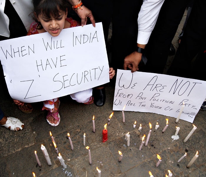 People from all walks of life came to pay their respect to the ones who fell during the terror attacks at the historic Gateway of India. These activists lit up candles and held up placards urging the government to take strong measures to curb such attacks in future. After all, these attacks had highlighted the lack of coherence of India?s counter terrorism security.<br /> <br /> 

There were spontaneous singings of the national anthem. People stood on dividers, on tops of cars or buses or vans. And mourners lit candles on the pavement and the road, turning a usually frenetic area of Mumbai into numerous mini-shrines for the dead.(AFP photo)