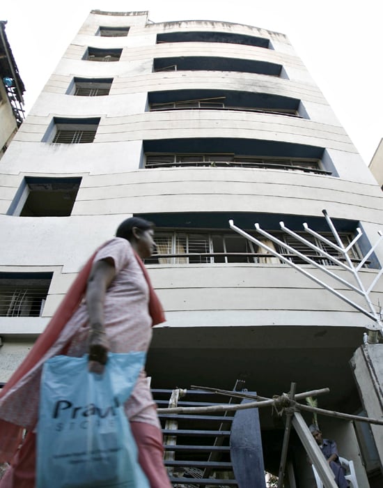 However, life goes on as usual on the street below with people immersed in their daily affairs, forgetful of the tragedy that will forever remain etched on Mumbai's psyche.(AFP photo)