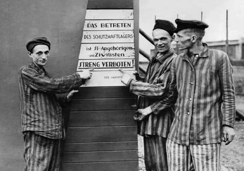 <span class="lh16 fa fs12 fb">A picture dated April 10 1945 of prisoners liberated by US troops from the Hanover-Harlen Nazi concentration camp. They point to a sign taken from the entrance to the camp which states that civilian visitors are strictly prohibited from entering. (AFP Photo)</span>