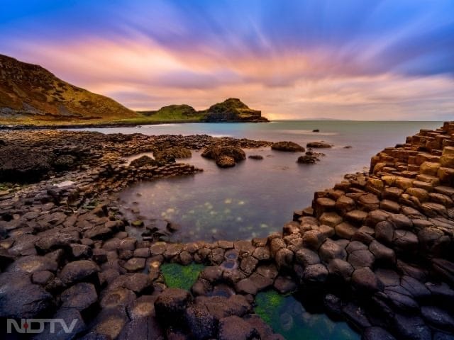 4. Walk the Giant's Causeway: Northern Ireland's Giant's Causeway is formed by 40,000 basalt columns shaped by volcanic activity. Paired with local legends, the site offers both geological wonder and cultural storytelling.