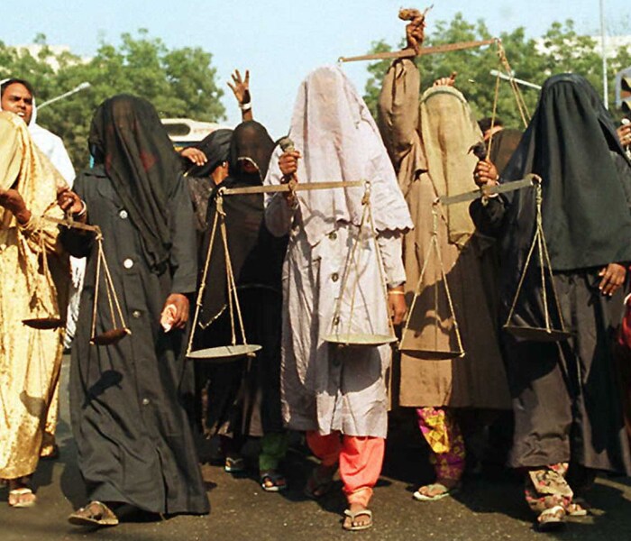 Veiled Muslim women seen carrying the scales of justice during a march, demanding compensation for the families of the people who were killed during these riots.<br><br>After the riots, the muslims demanded Babri Masjid to be reconstructed at the same spot whereas the Hindu community wanted to construct a temple there. (AFP Photo)