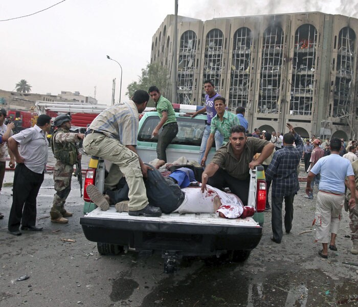 The bodies of victims are carried away from the blast scene in front of the ministry of Labor after a massive bomb attack. (AP Photo)