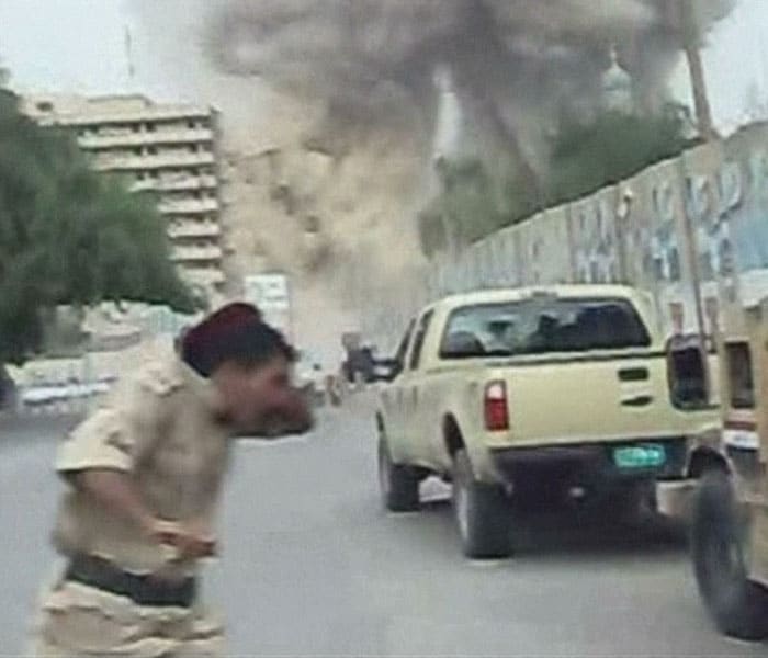 In this image from an amateur video a policeman man reacts as one of two huge car bombs explode in central Baghdad Sunday October 25 2009.<br />
<br />
The bombs killed at least 136 people in an apparent attempt to target the fragile city's government offices, Iraqi medical officials and authorities said. (AP Photo)