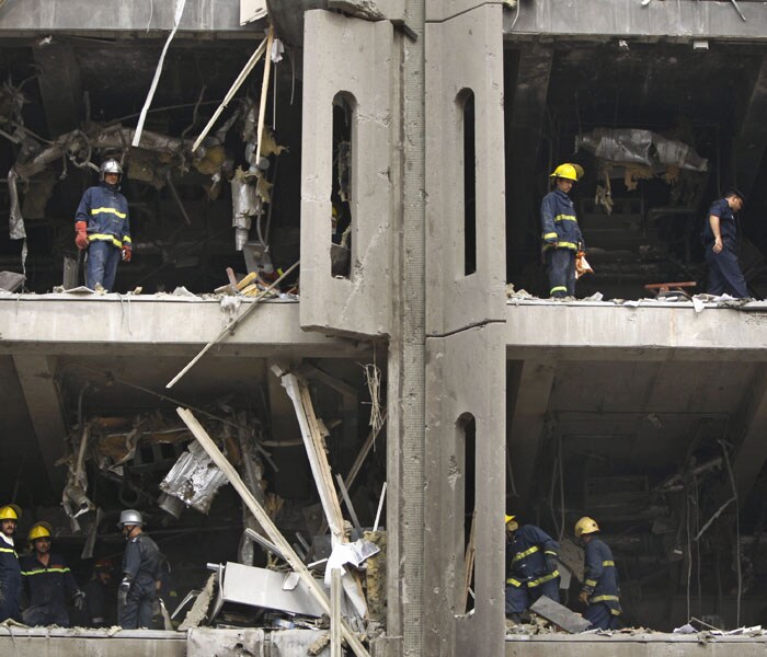 Iraqi firemen are seen working in different offices of the ministries of justice and labour following a suicide bombing on October 25, 2009.<br />
<br />
Twin suicide car bombs blasted the justice ministry and the provincial offices in central Baghdad killing at least 136 people and injuring over 600 others. (AFP Photo)