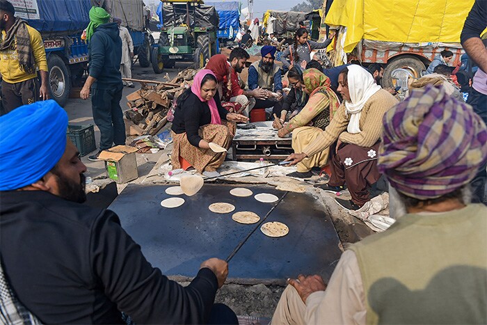 Farmers prepare 'langar' during a protest at Singhu Border, against the new farm laws, in New Delhi.