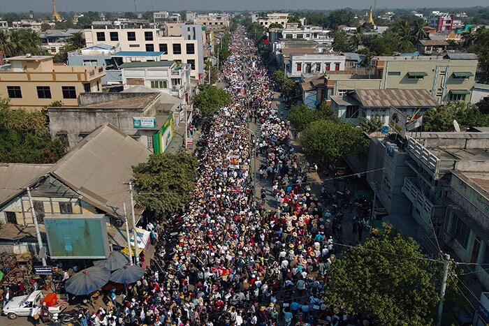 This aerial photo shows protesters marching on a road during a demonstration against the military coup in Shwebo in Myanmar's Sagaing Region on February 13, 2021