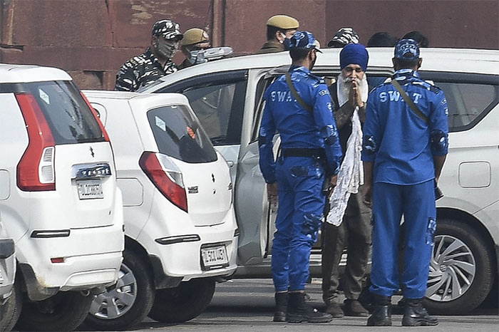 Iqbal Singh (C in blue turban), one of the accused in connection with the Red Fort violence on India's Republic Day following the farmers' protest against the central government's agriculture reform is taken to the Red Fort for a police investigation in New Delhi on February 13, 2021.