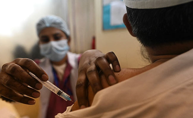 A medical worker inoculates a frontline worker with a coronavirus vaccine at a vaccination centre in Delhi.