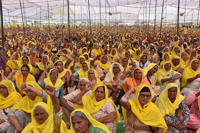 Women farmers shout slogans as they continue to demonstrate against the central government's recent agricultural reforms on the occasion of International Women's Day at the Tikri border, in Bahadurgarh in the state of Haryana on March 8, 2021.