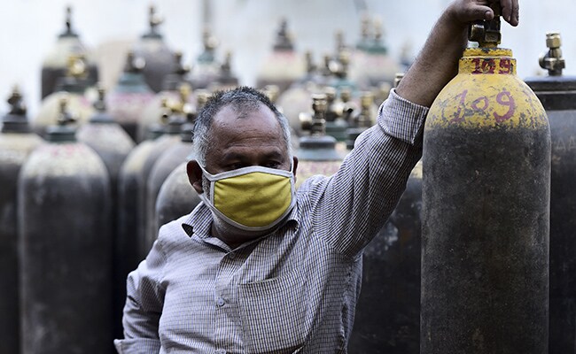 A man waits to refill a medical oxygen cylinder for coronavirus patients in Allahabad.