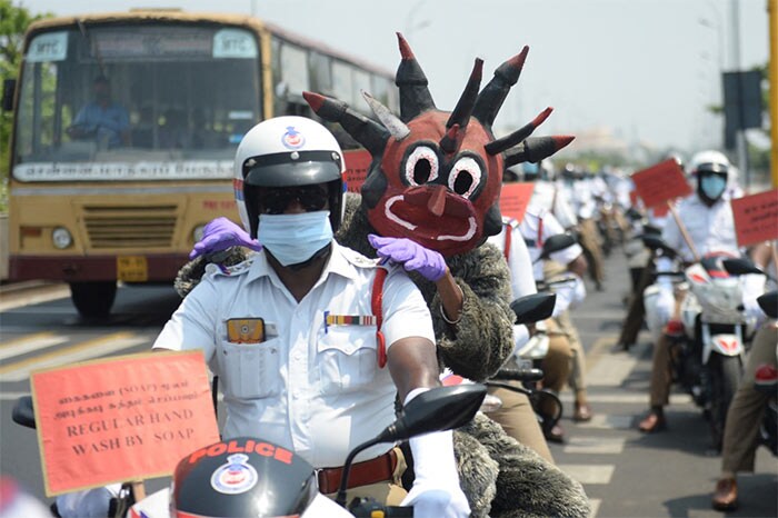 A policeman dressed up as demon resembling coronavirus takes part in a Covid awareness rally in Chennai.