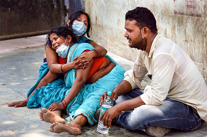 Family members mourn the death of a COVID-19 victim at Patna Medical College and Hospital (PMCH), during the second wave of the coronavirus pandemic , in Patna.