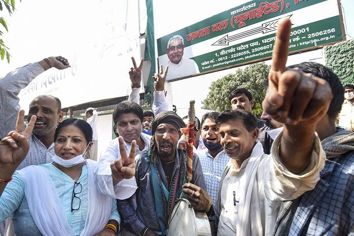 Janata Dal (United) supporters react as officials count votes