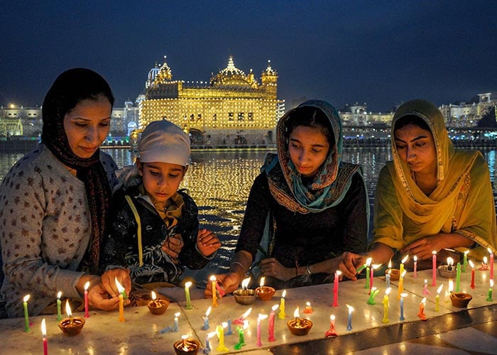 Devotees light candles at Harmandir Sahib (Golden Temple) in Amritsar. 
Many people also offered prayers and took a holy dip in the "sarovar" to mark the celebration.